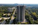 Extensive aerial view of the high-rise condo building and surrounding green space provides a sense of its location at 2660 Peachtree Nw Rd # 11G, Atlanta, GA 30305