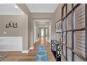 Inviting hallway with wood floors, wainscoting and view into rooms with decorative ceilings at 586 Shoal Mill Sw Rd, Smyrna, GA 30082