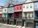 Charming townhome exteriors with colorful facades, garages, and front balconies at 166 Color Cir, Atlanta, GA 30317