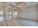 Bright, open-concept living room features coffered ceilings and hardwood floors at 177 Haverling Pass, Hampton, GA 30228