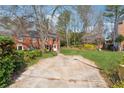 Two-story brick home with a spacious backyard and driveway at 185 Willow Stream Ct, Roswell, GA 30076