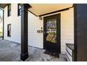 Close-up of the home's front door featuring a black frame and stylish hardware at 1051 Curran Nw St, Atlanta, GA 30318