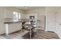 Modern kitchen featuring white cabinets, granite countertops, and stainless steel appliances at 186 Sonoma Drive, Dallas, GA 30157