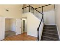 Bright foyer features hardwood floors and staircase to upper level of the home at 5928 Springfair Run, Lithonia, GA 30038