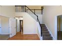 Inviting foyer with hardwood floors, staircase, and high ceilings to welcome guests at 5928 Springfair Run, Lithonia, GA 30038