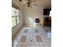 Dining room with large windows, ceiling fan, and tile floors at 470 Yearling Dr, Loganville, GA 30052