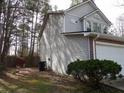 Exterior view of the home showing the siding, foundation plantings, and surrounding trees at 545 Haymarket Ct, Riverdale, GA 30296