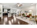 Open-concept living room featuring dark floors, stylish furnishings, and ample natural light at 2474 Norwood Park Xing, Atlanta, GA 30340