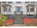 Inviting front entrance with a stylish blue door and well-maintained landscaping at 930 Camden Hill Ct, Lawrenceville, GA 30046