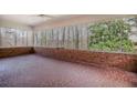 Enclosed sunroom with brick accents and a mosaic tile floor, providing a bright, airy space at 11765 Mountain Laurel Dr, Roswell, GA 30075