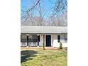 Welcoming front porch with seating and 'welcome' sign, offering a charming entry to the home at 187 Bowden Rd, Ellenwood, GA 30294