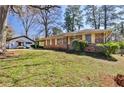A charming single-story brick house with a well-maintained lawn and a detached garage at 1949 Capri Dr, Decatur, GA 30032