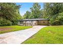 Well-maintained home with a spacious driveway and lush green lawn at 2403 Dawn Dr, Decatur, GA 30032