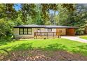Inviting home with a charming front porch and well-manicured lawn at 2403 Dawn Dr, Decatur, GA 30032