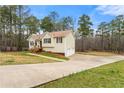 Well-maintained home featuring a long driveway leading to an attached two-car garage at 370 Burton Dr, Douglasville, GA 30134