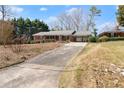 Charming brick home featuring a long driveway and landscaped front yard at 1421 Downs Sw Dr, Atlanta, GA 30311