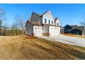 Side view of home highlighting manicured lawn, attached two-car garage, and classic architectural design at 20 Running Nw Ter, Cartersville, GA 30121