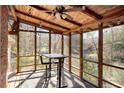 Cozy screened-in patio with a wooden ceiling, string lights, and a view of the backyard at 2360 Leisure Lake Dr, Atlanta, GA 30338