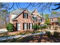 Lovely brick home with classic shutters, complemented by neatly trimmed bushes at 305 Collegiate Dr, Powder Springs, GA 30127