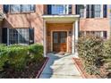 Inviting entryway with a double wooden door, sidelights, and manicured bushes along the walkway at 305 Collegiate Dr, Powder Springs, GA 30127