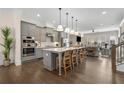 Modern kitchen featuring a large center island, stainless steel appliances, and open concept living area at 4336 Walsh Dr, Dunwoody, GA 30338