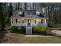Attractive home with a porch, complemented by lush greenery and a well-manicured lawn, creating a warm and inviting ambiance at 4382 Conwhey Sw Ct, Smyrna, GA 30082