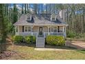 Inviting two-story home with a welcoming front porch, garden, and well-maintained lawn in a serene neighborhood at 4382 Conwhey Sw Ct, Smyrna, GA 30082