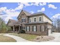 Beautiful two-story brick and stone home with a covered porch and well-maintained landscaping at 2845 Echols Rd, Cumming, GA 30041