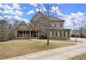 Charming home with stone and brick exterior, inviting front porch, and spacious front yard at 2845 Echols Rd, Cumming, GA 30041