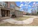 A lovely home boasting a stone and brick exterior, complemented by a concrete walkway at 2845 Echols Rd, Cumming, GA 30041