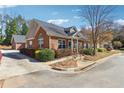 Brick home on corner lot with manicured landscaping, driveway, and architectural interest at 3310 Raes Creek Rd # 16, Marietta, GA 30008