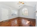 Bright living room showcasing hardwood floors, vaulted ceiling, fireplace, and plantation shutters at 3310 Raes Creek Rd # 16, Marietta, GA 30008