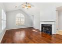 Open living room featuring hardwood floors, cathedral ceiling, fireplace, and large window at 3310 Raes Creek Rd # 16, Marietta, GA 30008