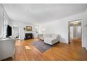 Bright living room with hardwood floors, white walls, fireplace, and comfortable seating at 1201 Thomas Rd, Decatur, GA 30030