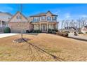 Beautiful home with manicured front lawn and landscaping in a suburban neighborhood at 257 Lakestone Pkwy, Woodstock, GA 30188