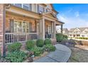 Inviting front porch with rocking chairs and lush landscaping creates a cozy outdoor space at 257 Lakestone Pkwy, Woodstock, GA 30188