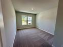 Cozy bedroom with neutral carpeting, a bright window, and freshly painted walls at 2624 Mourning Dove Drive (Lot 42), Grayson, GA 30017