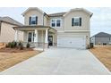 Beautiful home with an attached garage, showcasing a well-maintained lawn and inviting curb appeal at 2624 Mourning Dove Drive (Lot 42), Grayson, GA 30017