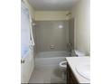 A traditional bathroom featuring a shower-tub combo and a vanity at 7123 Williamsburg Dr, Riverdale, GA 30274