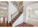 Inviting home entryway featuring a staircase with wood and iron railing and hardwood floors at 416 Culloden Moor Dr, Mcdonough, GA 30253