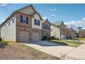 Two-story home with brick and siding, showcasing its driveway and suburban setting at 416 Culloden Moor Dr, Mcdonough, GA 30253