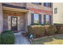 Close-up of the home's front door with brick facade and neatly trimmed landscaping at 416 Culloden Moor Dr, Mcdonough, GA 30253