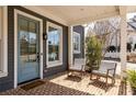 Cozy front porch with brick flooring and comfortable rocking chairs, perfect for relaxing at 240 Mado Ln, Chattahoochee Hills, GA 30268
