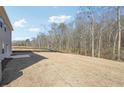 Large backyard with grass, trees, and a wooden privacy fence at 345 Orwell Dr, Social Circle, GA 30025