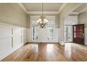 Elegant dining room with hardwood floors, chandelier, and detailed trim at 627 Warsaw Rd, Roswell, GA 30075