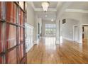 Bright, spacious foyer with hardwood floors, wainscoting, and high ceilings, leads into the living area at 627 Warsaw Rd, Roswell, GA 30075