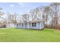 Lovely home with an inviting entrance and a spacious green lawn at 8199 Cousins St, Douglasville, GA 30134
