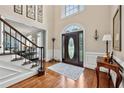 Elegant foyer featuring hardwood floors, staircase, and decorative lighting at 370 Fairleaf Ct, Alpharetta, GA 30022