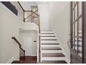 Inviting foyer with hardwood floors, staircase, and natural light streaming through the front door at 3724 Via Secco Ln, Suwanee, GA 30024