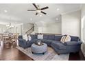 Spacious living room featuring a comfortable sectional sofa and a view of the dining area at 3724 Via Secco Ln, Suwanee, GA 30024